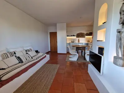 a bedroom with a large bed and a table at Incrível T1 na praia da Oura in Albufeira