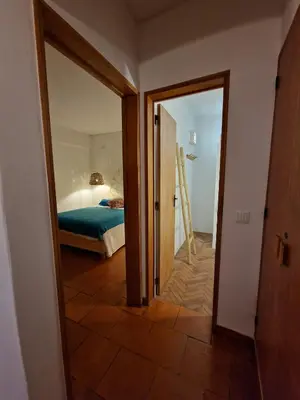 a room with a bedroom with a bed and a mirror at Incrível T1 na praia da Oura in Albufeira