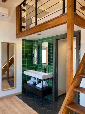 a bathroom with a sink and green tiles at Casa Malpique in Albufeira