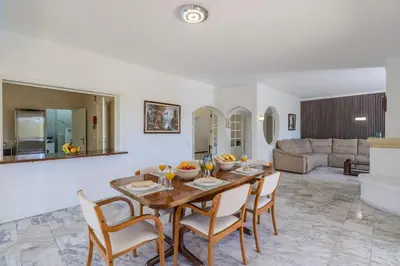 a dining room with a wooden table and chairs at #336 Vila Sol by Home Holidays in Sesmarias