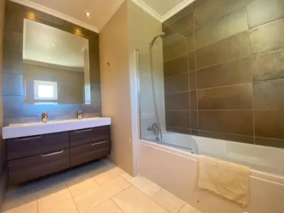 a bathroom with a tub and a sink and a shower at Villa 