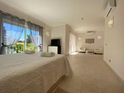 a bedroom with a bed and a large window at Villa 