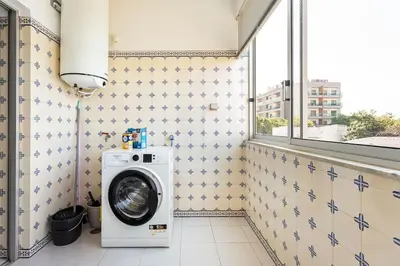 a washing machine in a bathroom with a window at Amoreira 3br City Center at Homesbyfc in Faro