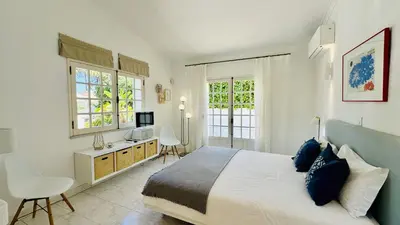 a bedroom with a bed and a desk with a computer at Villa Verde by Check-in Portugal in Vilamoura