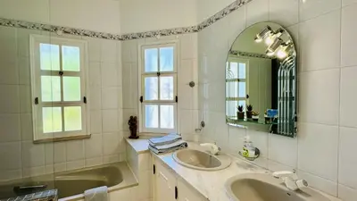 a white bathroom with a sink and a mirror at Villa Verde by Check-in Portugal in Vilamoura