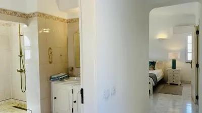 a bathroom with a sink and a shower and a bed at Villa Verde by Check-in Portugal in Vilamoura