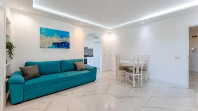 a living room with a blue couch and a table at Bright 1BDR Flat in Albufeira by LovelyStay in Albufeira