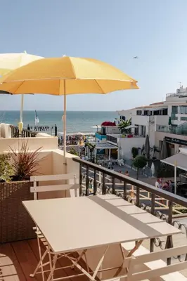 a dining room with a wooden table and chairs at Olhos de Água Beach Apartments by Mycelia in Olhos de Água