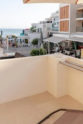 a wooden table and two chairs in a room at Olhos de Água Beach Apartments by Mycelia in Olhos de Água