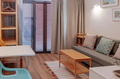 a kitchen with wooden cabinets and white counter tops at Olhos de Água Beach Apartments by Mycelia in Olhos de Água