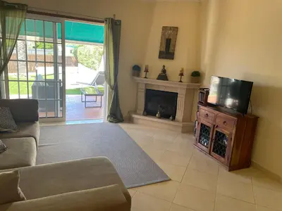 a living room with a tv and a fireplace at Açoteias Townhouse Villa T2 1 in Roja- Pé