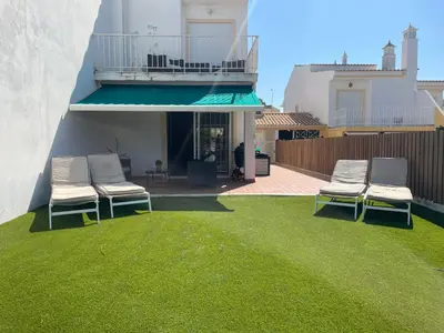 a kitchen with white cabinets and a stove top oven at Açoteias Townhouse Villa T2 1 in Roja- Pé