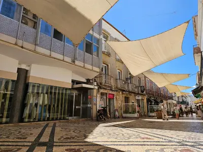 a street in a town with buildings and umbrellas at Blife Eduardya - private rooms at Santantonya 5th floor in Faro