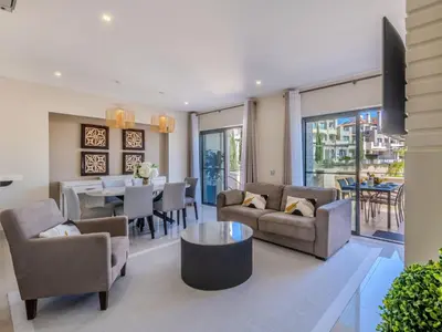 a living room with a couch and a table at Apartment Pine Hills Diadema-16 by Interhome in Vilamoura