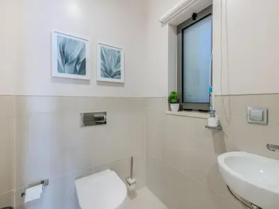 a bathroom with a sink and a toilet and a window at Apartment Pine Hills Diadema-16 by Interhome in Vilamoura