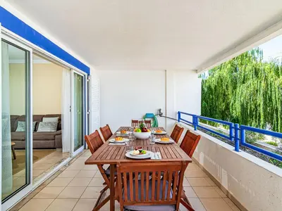 a dining room with a table and chairs on a balcony at Apartment Mediterrâneo by Interhome in Vilamoura