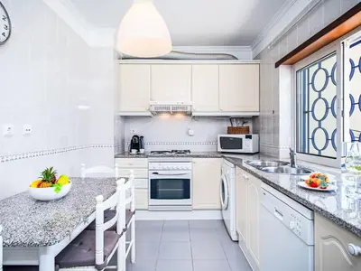 a kitchen with white cabinets and a sink at Apartment Mediterrâneo by Interhome in Vilamoura
