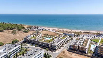 an aerial view of a resort and the ocean at Luxury Flats with Pool in Quarteira by LovelyStay in Quarteira