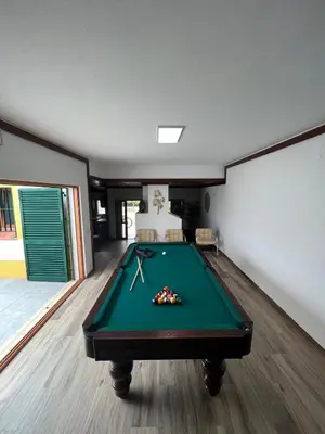 a pool table in the middle of a room at Villa with pool in the Heart of Oura - Albufeira in Albufeira