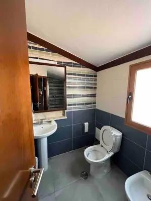 a bathroom with a toilet and a sink at Villa with pool in the Heart of Oura - Albufeira in Albufeira