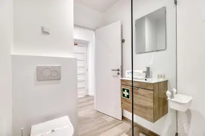 a white bathroom with a toilet and a sink at Sunshine Apartment in Vilamoura