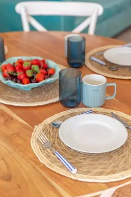 a table with plates and a bowl of fruit on it at Micului Refugiu in Albufeira