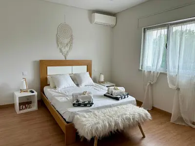 a bedroom with a large bed with two trays on it at Casa Vila Real in Mem Moniz