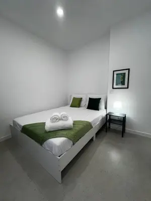 a bedroom with a bed with two towels on it at Cantinho da Paz in Faro