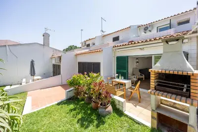 a backyard of a house with a patio at Alfamar Beach Apartment in Albufeira