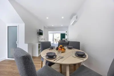 a dining room with a table with fruit on it at Alfamar Beach Apartment in Albufeira