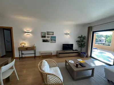 a living room with a couch and a table at Janelas do Oceano by FHR in Quarteira