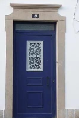 a blue door with a window on a building at Blue House - City's Heart in Faro