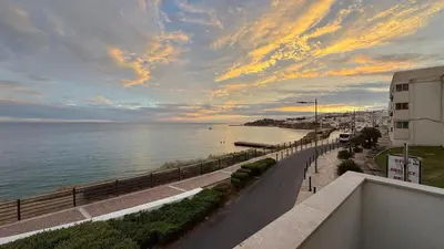 a view of the ocean from a balcony with a street light at Apartamento T1 Pau da Bandeira in Caliços