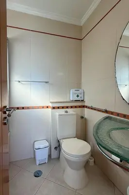 a bathroom with a toilet and a bath tub at Apartamento T1 Pau da Bandeira in Caliços