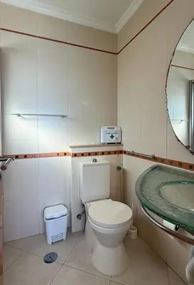 a bathroom with a toilet and a sink at Apartamento T1 Pau da Bandeira in Caliços