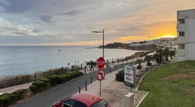 a car parked on a road next to the ocean at Apartamento T1 Pau da Bandeira in Caliços