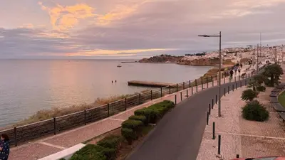 a street next to a body of water at Apartamento T1 Pau da Bandeira in Caliços