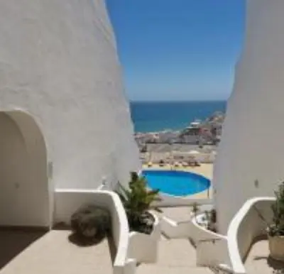 a balcony with a view of a swimming pool at Ocean view Cerro Branco with pool in Albufeira