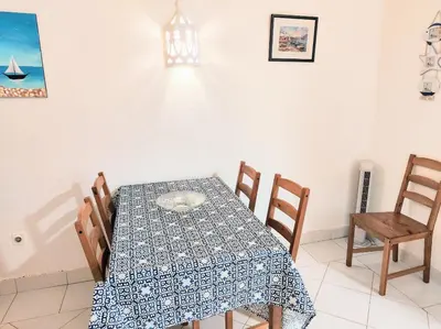 a dining room with a table and chairs at Ocean view Cerro Branco with pool in Albufeira