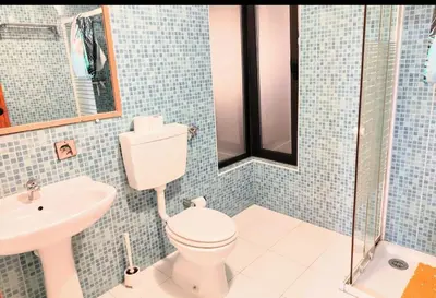 a bathroom with a toilet and a sink at Ocean view Cerro Branco with pool in Albufeira