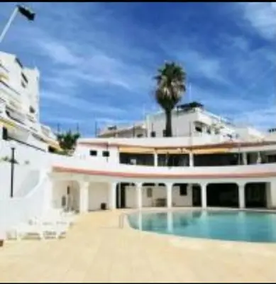 a large building with a swimming pool in front of it at Ocean view Cerro Branco with pool in Albufeira