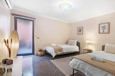 a bedroom with two beds and a window at Sunshine Villa em Vilamoura in Vilamoura