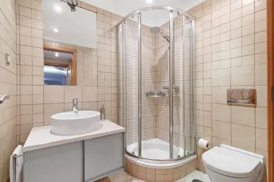 a bathroom with a shower and a sink and a toilet at Sunshine Villa em Vilamoura in Vilamoura