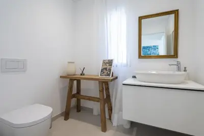 a bathroom with a sink and a toilet and a mirror at Villa Cyan by SAPvillas in Vilamoura