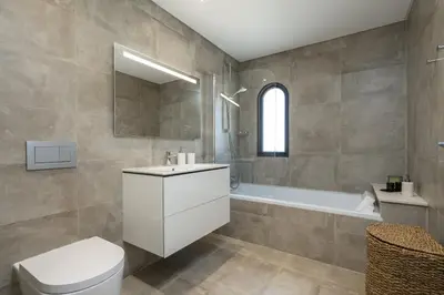 a bathroom with a toilet and a sink and a tub at Villa Cyan by SAPvillas in Vilamoura