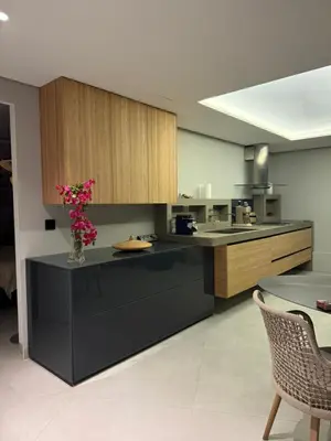 a kitchen with a counter with a vase of flowers on it at Villa mar e Serra in Loulé