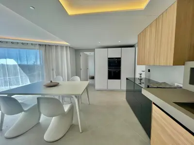 a kitchen with a white table and white chairs at Villa mar e Serra in Loulé