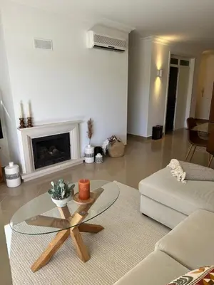 a living room with a coffee table and a fireplace at Vale de Lobo - stylish beach and golf retreat in Almancil