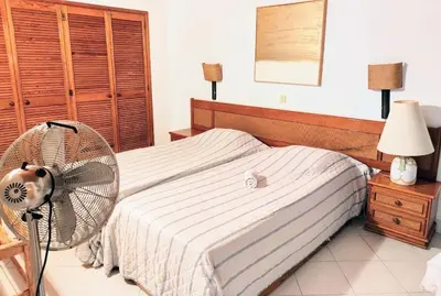 a bedroom with a bed with a fan at Albufeira Pescadores Sea view in Albufeira