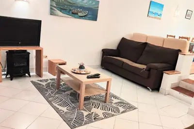 a living room with a couch and a coffee table at Albufeira Pescadores Sea view in Albufeira